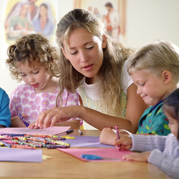 Therapist and children in group play therapy session