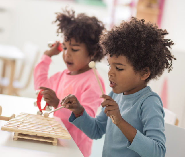 Kids playing on a xylophone