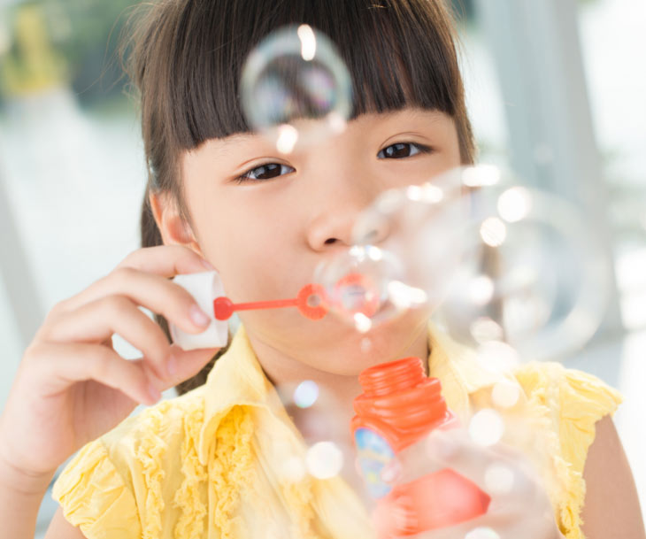 Girl blowing bubbles