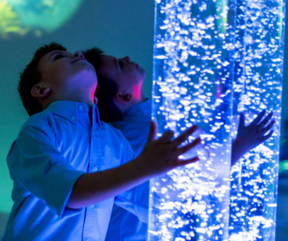 Children looking at bubbles in a tube