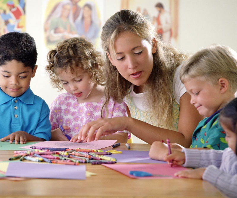 Therapist and children in group play therapy session